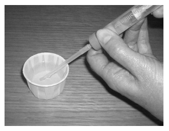 Put the end of the tube into the urine in the beaker and pull back the syringe to fill it
